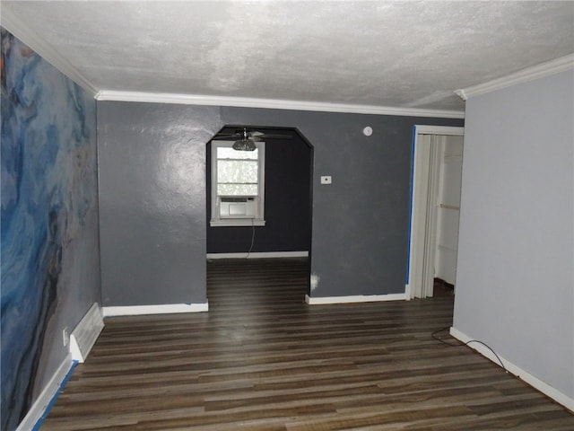 unfurnished room featuring crown molding, dark hardwood / wood-style floors, a textured ceiling, and ceiling fan