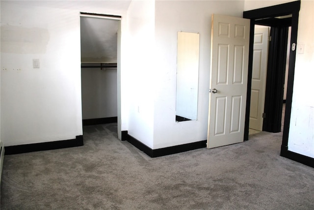 unfurnished bedroom with a closet and carpet