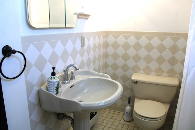 bathroom featuring tile walls, toilet, and tile patterned flooring