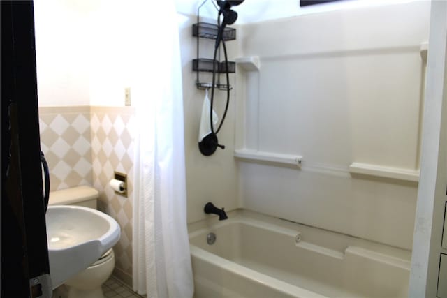 bathroom with toilet and shower / bath combo with shower curtain