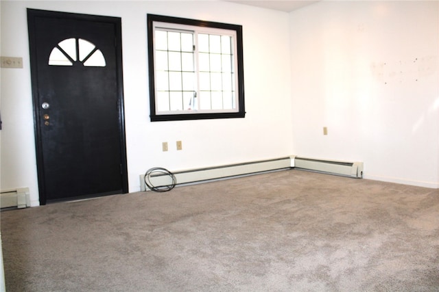 carpeted entrance foyer featuring a baseboard heating unit