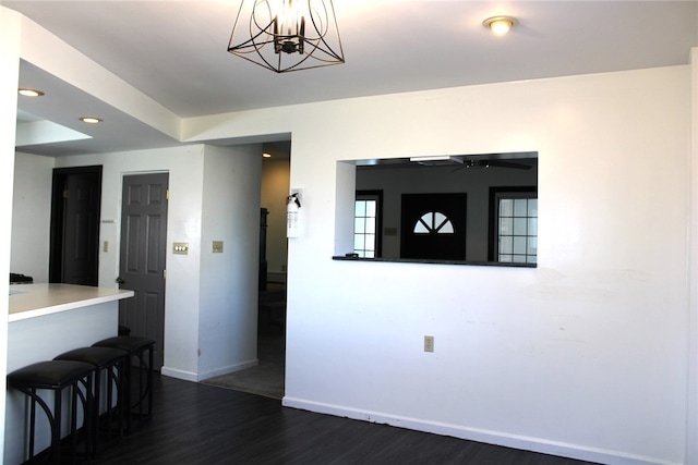 interior space with dark wood-type flooring and a notable chandelier