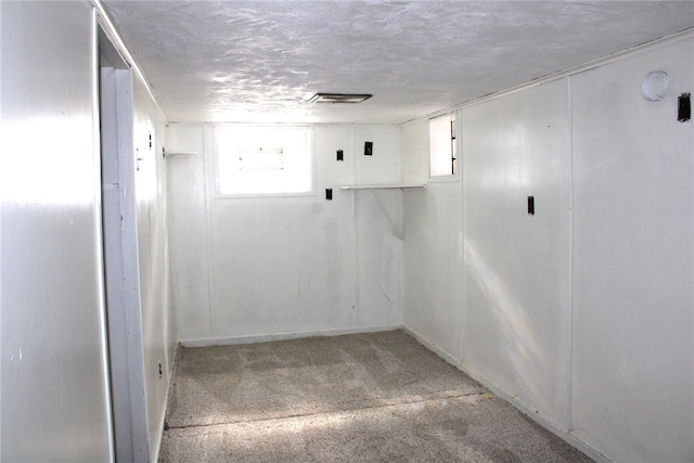 basement featuring a textured ceiling