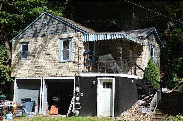 back of house featuring a balcony