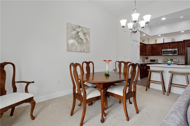 carpeted dining room featuring a chandelier