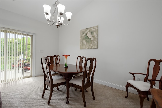 dining area with light carpet, lofted ceiling, and a chandelier