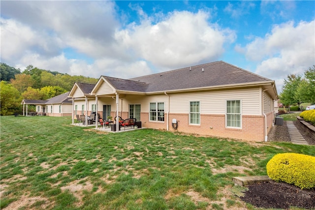 back of house with a patio, a yard, and central AC unit