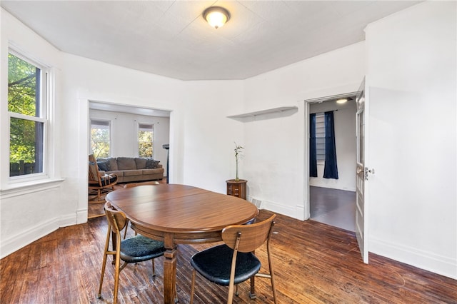 dining space with dark hardwood / wood-style flooring