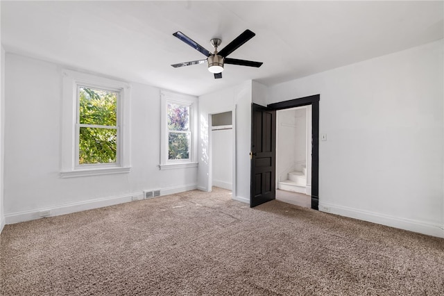 unfurnished bedroom featuring carpet and ceiling fan