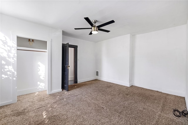 unfurnished bedroom featuring carpet floors, a closet, and ceiling fan