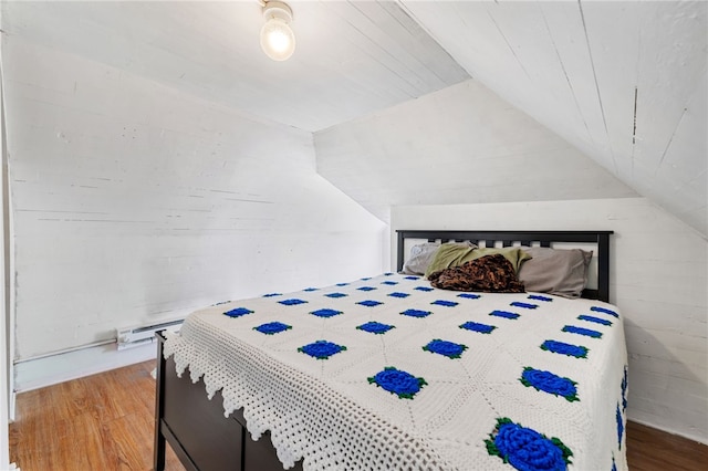 bedroom featuring lofted ceiling and wood-type flooring