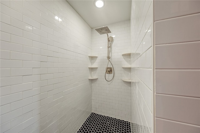 bathroom with a tile shower