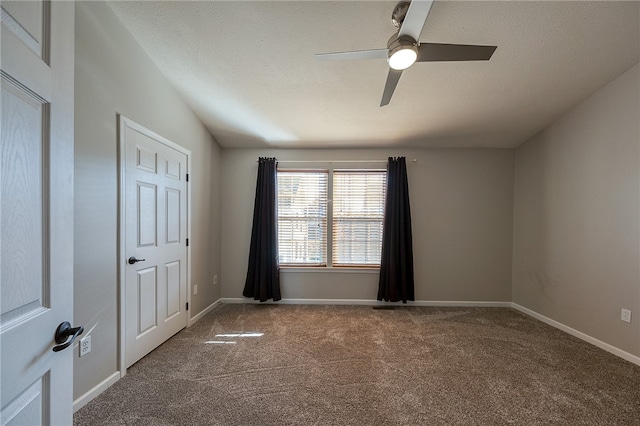 carpeted spare room featuring a textured ceiling and ceiling fan