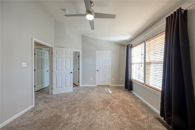 unfurnished bedroom with light carpet, vaulted ceiling, and ceiling fan