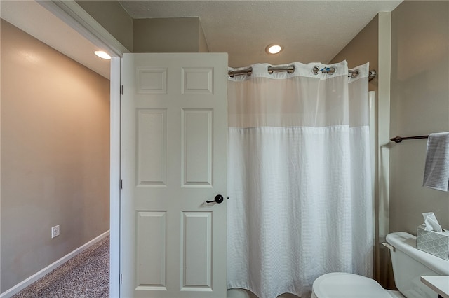 bathroom featuring toilet and walk in shower