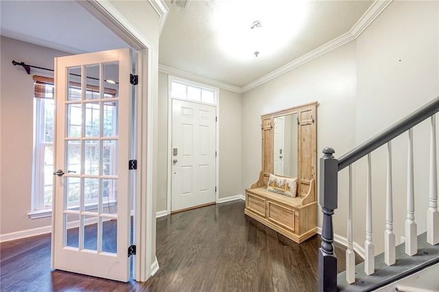 foyer featuring ornamental molding and dark hardwood / wood-style flooring