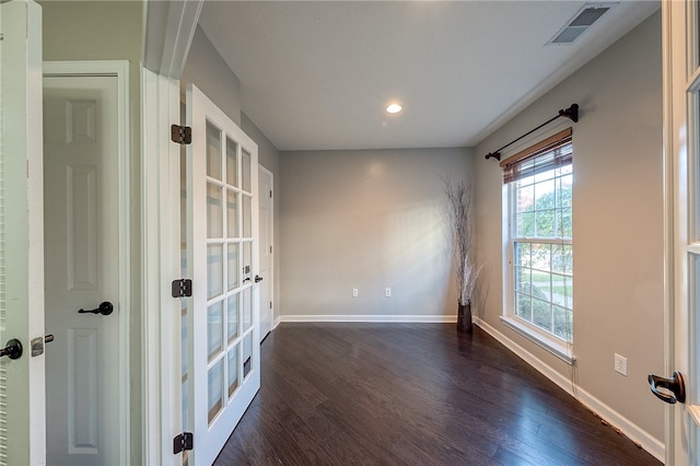 unfurnished room featuring french doors and dark hardwood / wood-style flooring