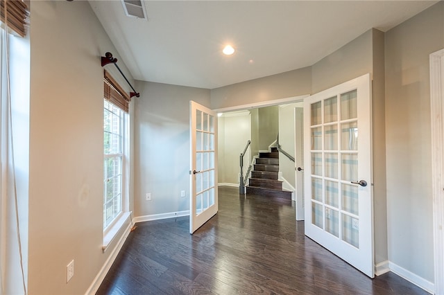 empty room with french doors and dark hardwood / wood-style floors