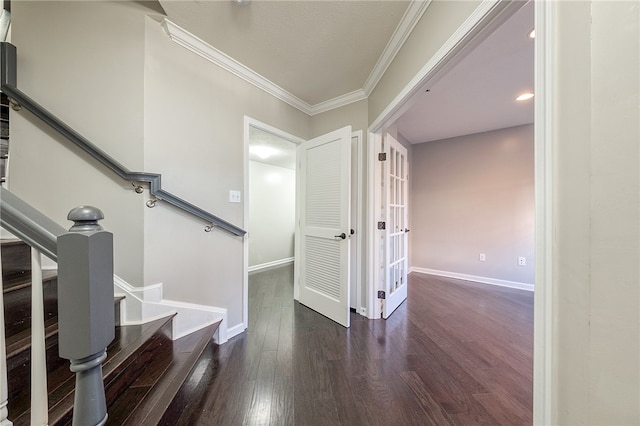 entrance foyer with ornamental molding and dark hardwood / wood-style floors