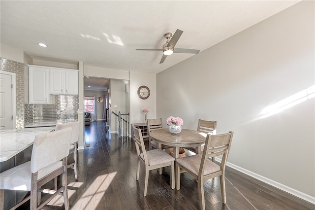 dining area with dark wood-type flooring and ceiling fan