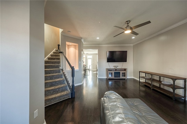 living room with crown molding, dark hardwood / wood-style floors, and ceiling fan