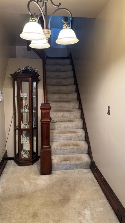 stairs featuring carpet flooring