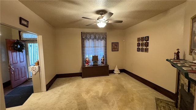 interior space featuring a textured ceiling and ceiling fan