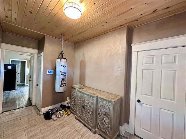 hallway featuring wooden ceiling and light wood-type flooring