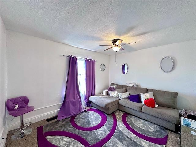 living room featuring a textured ceiling, carpet floors, and ceiling fan