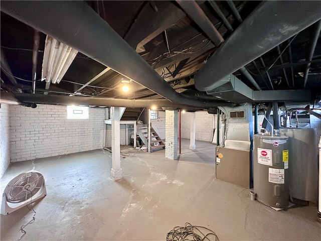 basement with brick wall and water heater