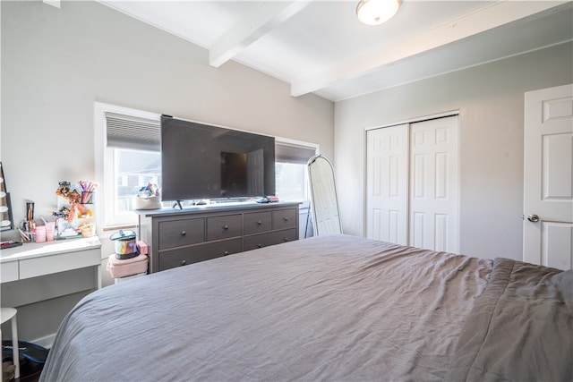 bedroom with a closet, beam ceiling, and multiple windows