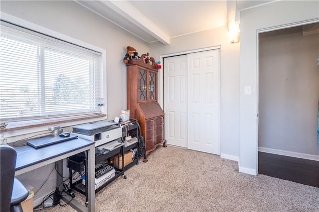 carpeted office featuring beam ceiling