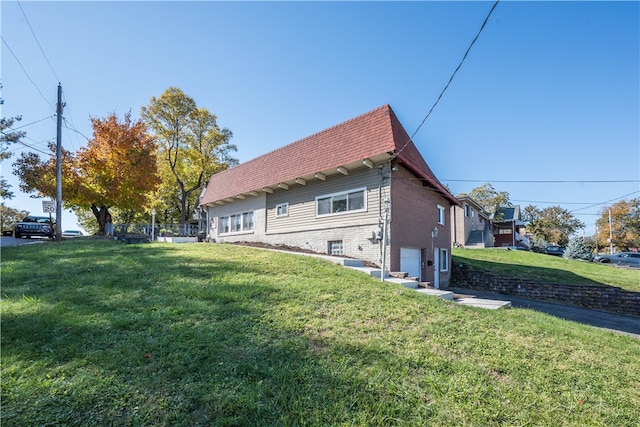 view of home's exterior with a lawn and a garage