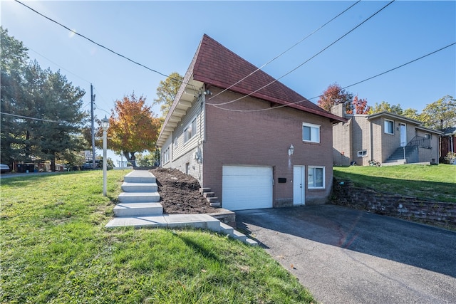 view of side of property with a yard and a garage