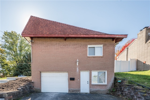 back of property with a garage