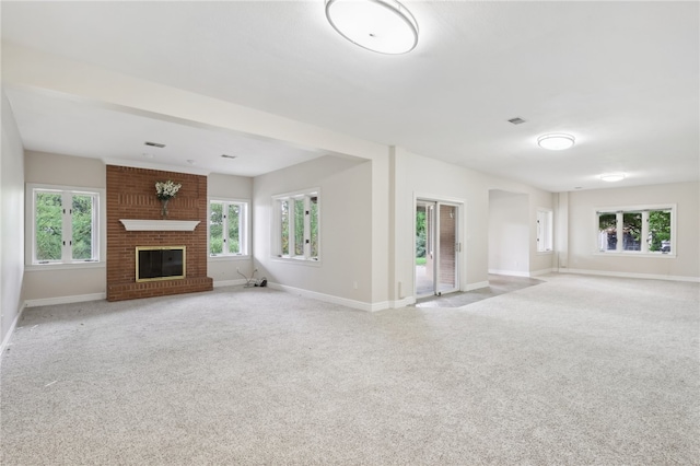 unfurnished living room with light carpet and a fireplace