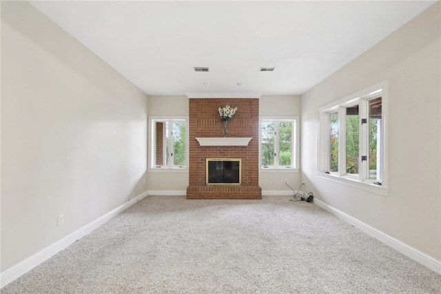 unfurnished living room featuring a fireplace and carpet flooring