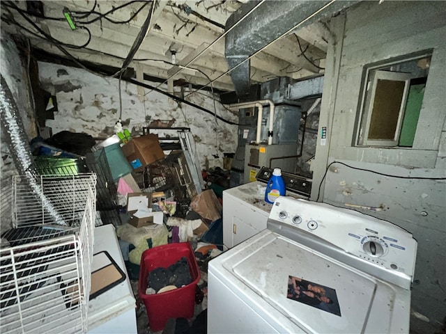 laundry room with independent washer and dryer, electric panel, and heating unit