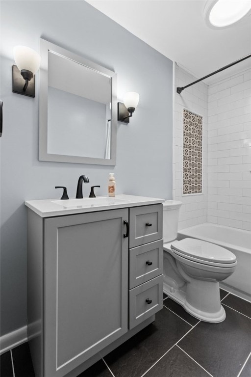 full bathroom featuring tiled shower / bath, vanity, toilet, and tile patterned flooring