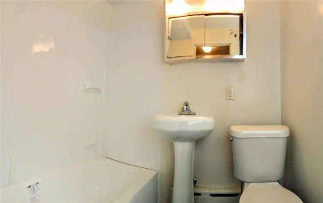 bathroom with shower with separate bathtub, a baseboard heating unit, and toilet