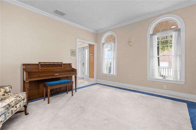 living area with ornamental molding and light colored carpet