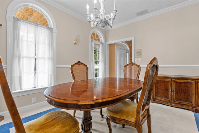 carpeted dining area featuring ornamental molding and a chandelier