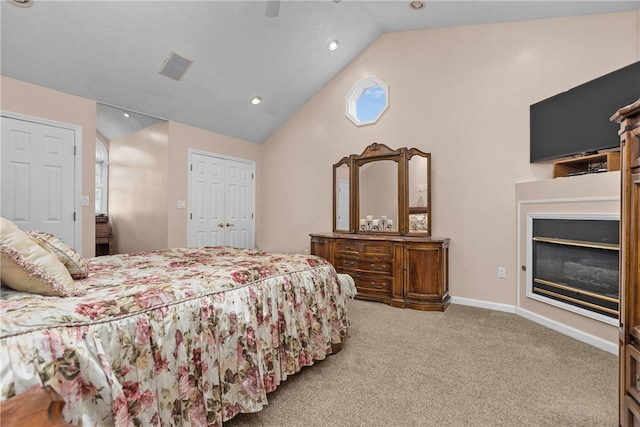 bedroom with lofted ceiling, light colored carpet, and ceiling fan