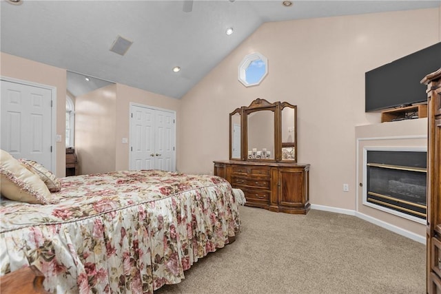 69 Orchard St, Carroll Twp, PA 15022 - bedroom featuring carpet flooring, a glass covered fireplace, a ceiling fan, high vaulted ceiling, and recessed lighting
