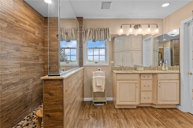 bathroom featuring vanity, a shower, and hardwood / wood-style flooring