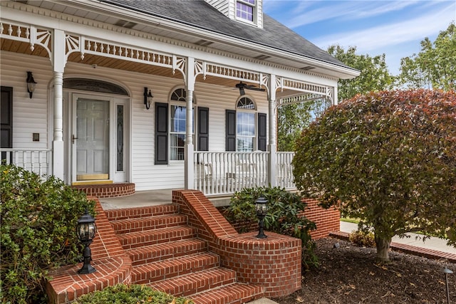 view of exterior entry with a porch