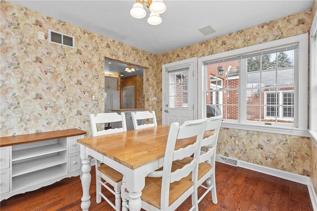 69 Orchard St, Carroll Twp, PA 15022 - dining area featuring wallpapered walls, dark wood-type flooring, baseboards, and a chandelier