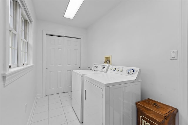 clothes washing area featuring washer and dryer and light tile patterned floors