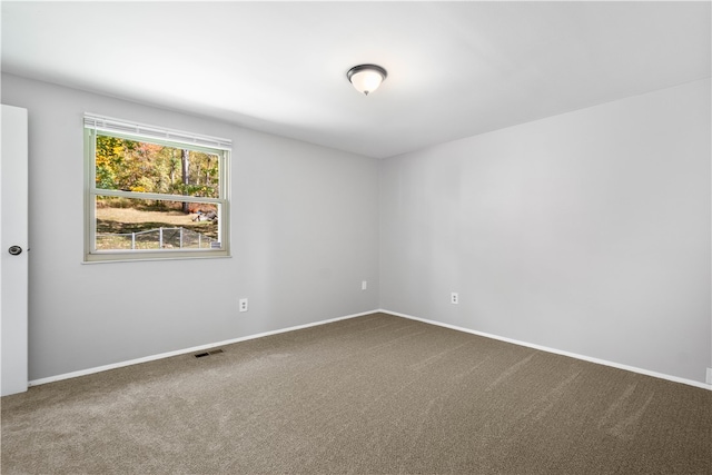 unfurnished room featuring carpet