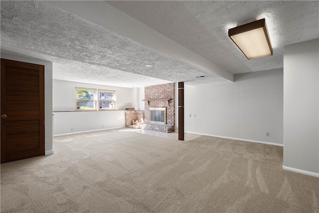 basement with carpet flooring, a textured ceiling, and a fireplace